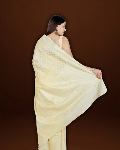 Serene Splendor: Cream Banarasi Cotton Saree with Beautiful Motif Border